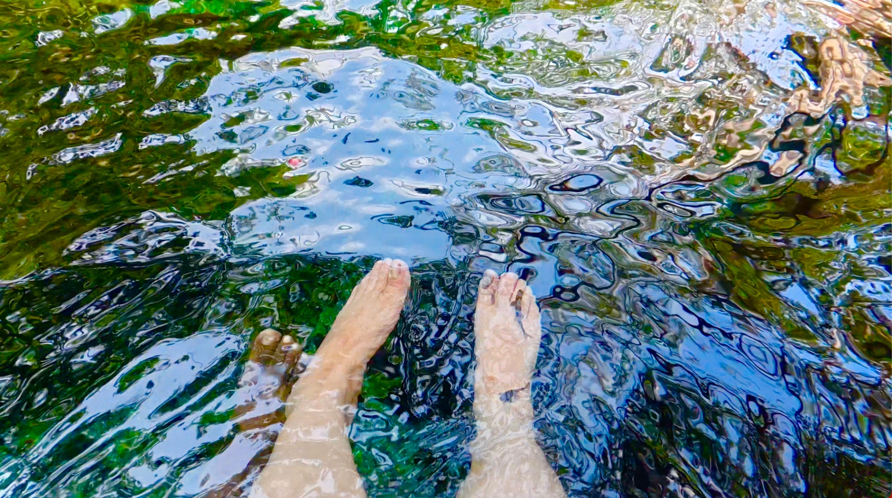 赤足浸入如镜的温泉水中